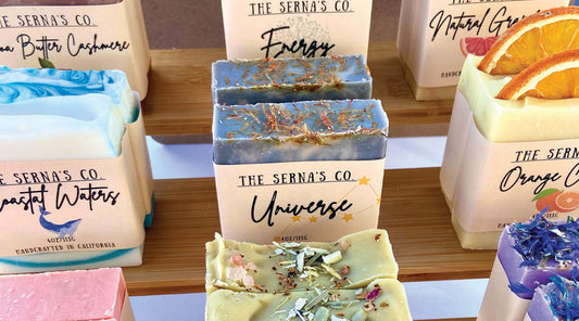 Handmade soap bar placed on the sand front of the ocean.