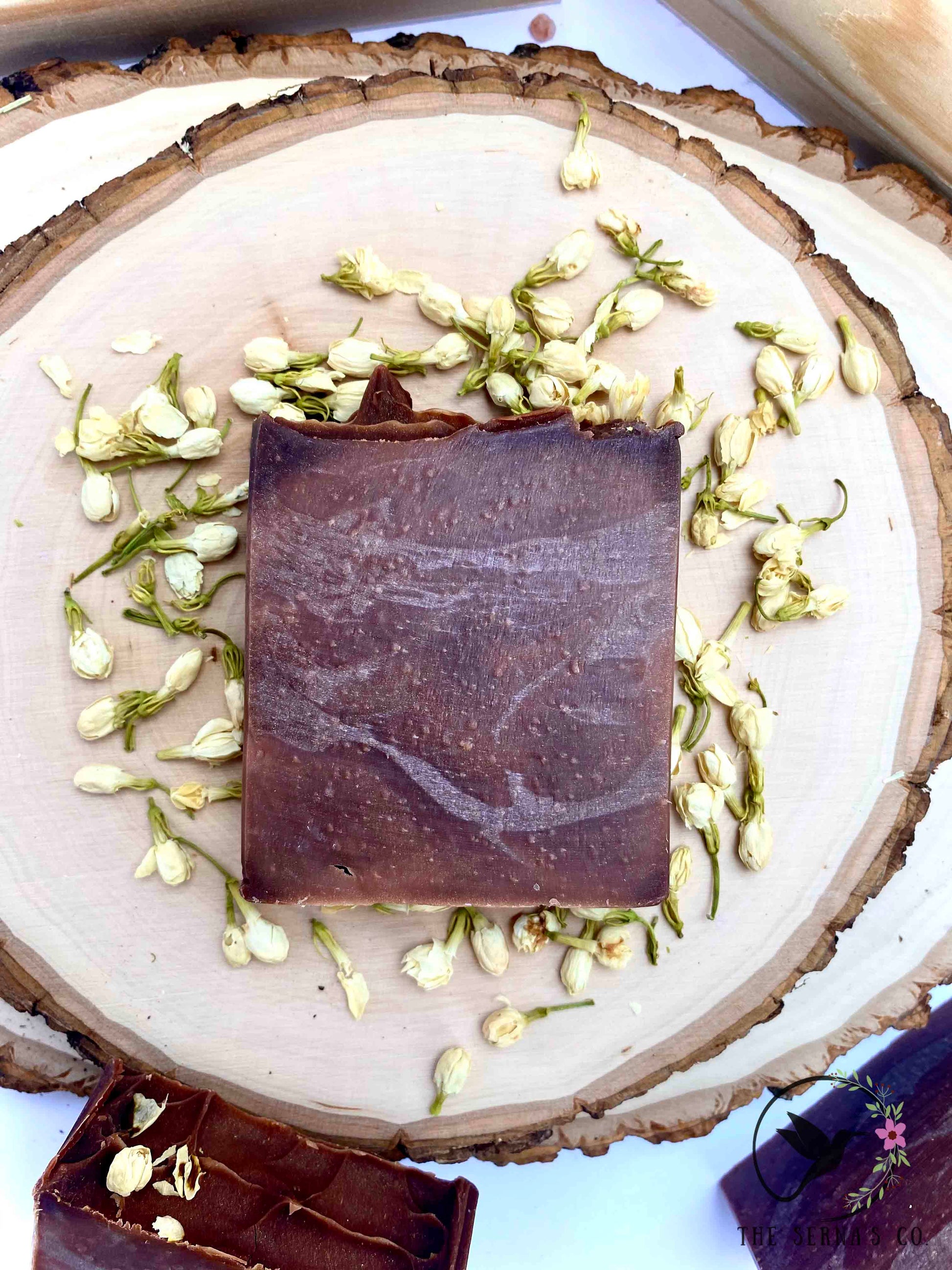 Soap bars displayed on wood with ingredients 