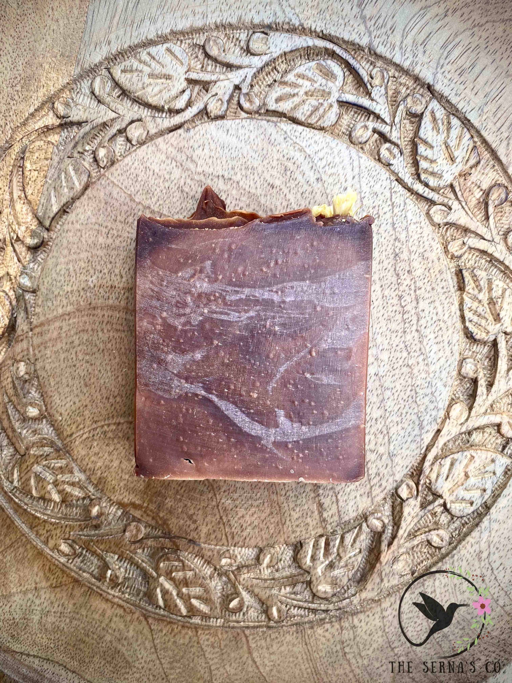 Soap bars displayed on wood with ingredients 